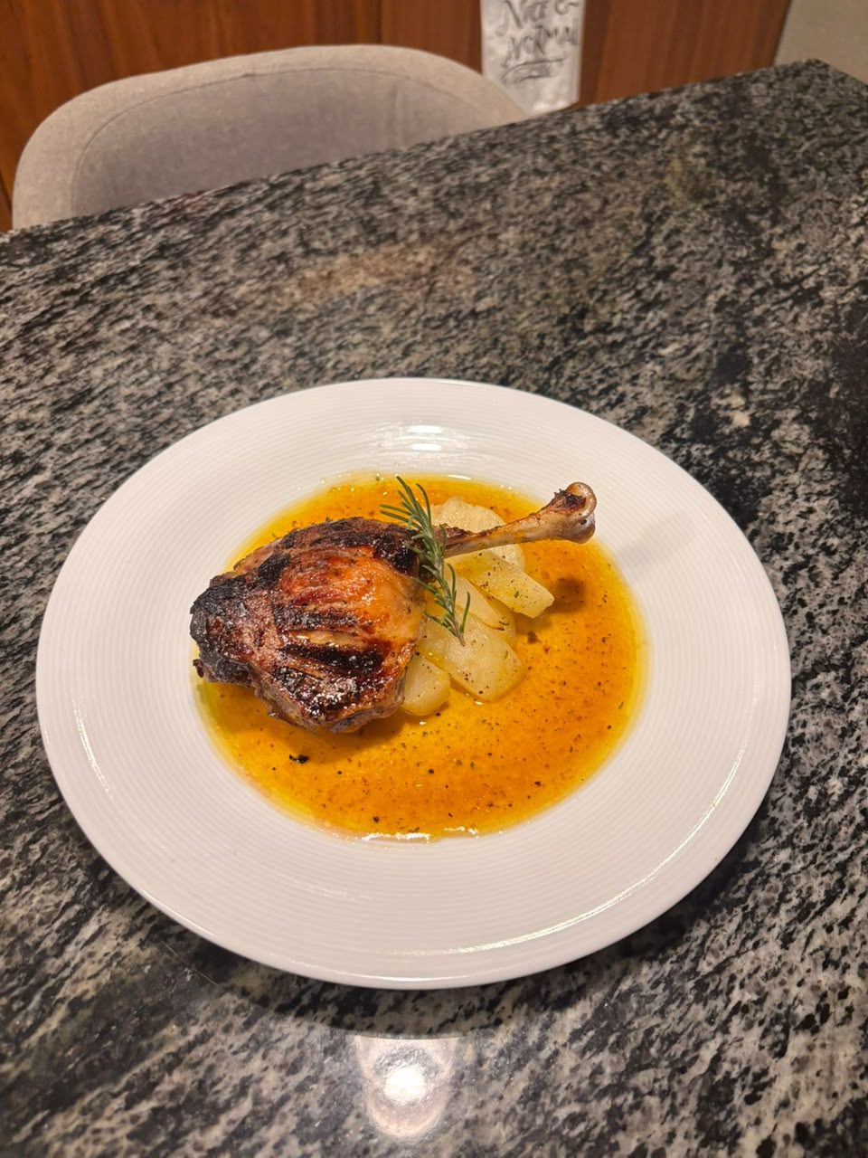 Reverse-seared duck leg with potatoes in a saffron-orange sauce